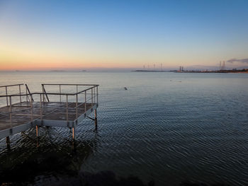 Scenic view of sea against clear sky during sunset