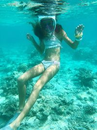 Young woman swimming in sea