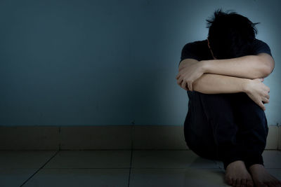 Rear view of man and woman sitting at home