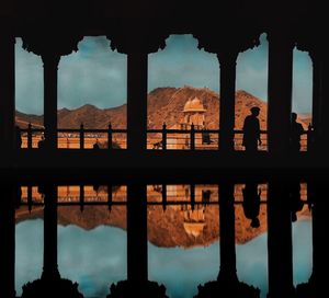 Reflection of buildings in city at sunset