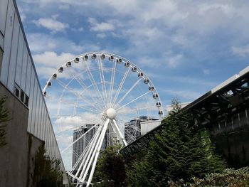 Low angle view of ferris wheel against sky