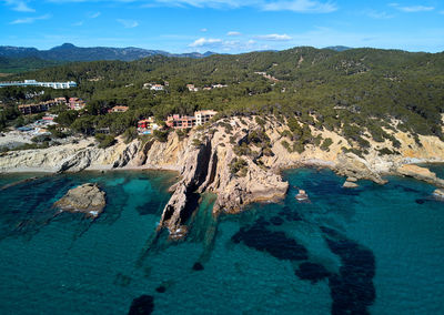 High angle view of sea and mountains against sky