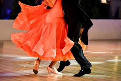 Low section of woman standing in city