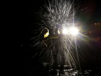 Low angle view of firework display at night