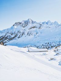 Scenic view of snow covered mountains against sky