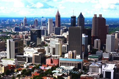 View of skyscrapers against cloudy sky