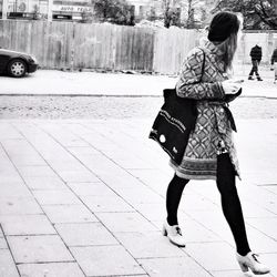 Woman standing on sidewalk