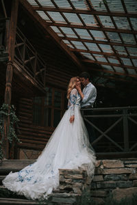 Full length of couple standing at cottage