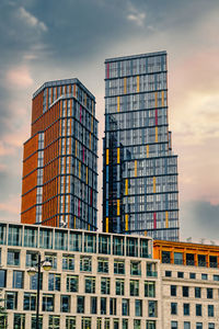 Low angle view of modern buildings against sky