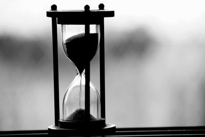 Close-up of hourglass on window sill