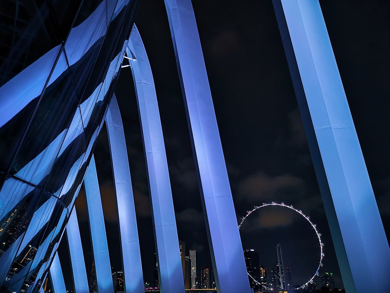 LOW ANGLE VIEW OF BRIDGE AGAINST SKY AT NIGHT