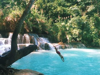 Woman jumping in water