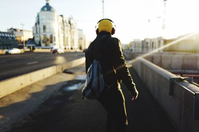 Rear view of woman standing on city street