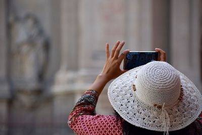 Midsection of woman photographing with mobile phone