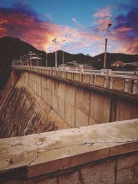 View of dam on bridge against sky during sunset