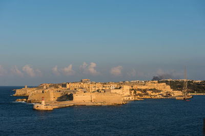 Fort on sea against blue sky