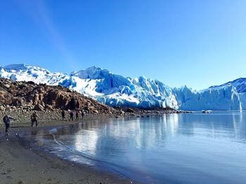 Scenic view of snowcapped mountains against clear blue sky