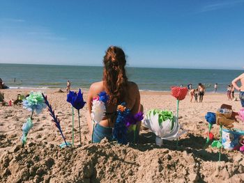 People on beach against sky