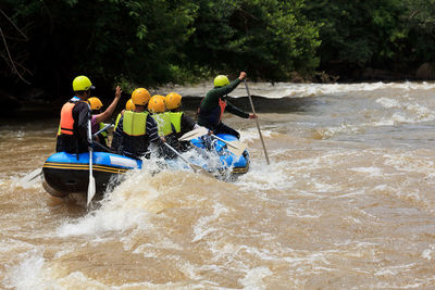 People on boat in river