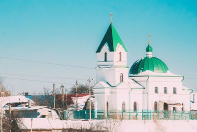 View of buildings in city against clear sky