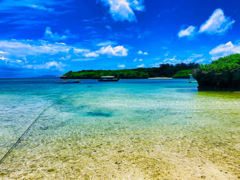 Scenic view of sea against blue sky