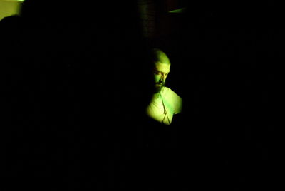 Close up of green leaf over black background