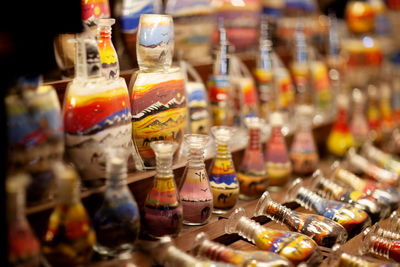 Decorative glass bottles with colored sand inside, sand souvenirs