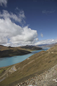 Scenic view of sea and mountains against sky