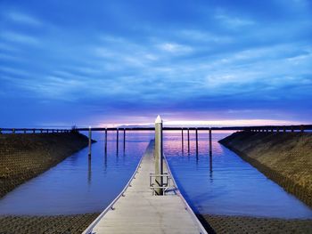 Pier over sea against sky