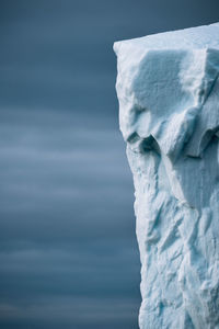 Close-up of frozen sculpture against sky