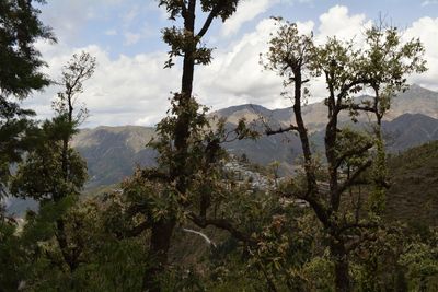 Scenic view of mountains against cloudy sky