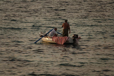 Man in boat sailing on sea