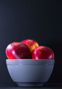 Close-up of apples in bowl on table