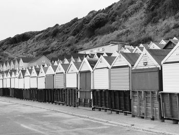 Row of beach huts against clear sky
