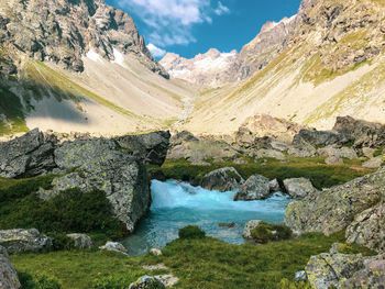 Scenic view of lake amidst mountains against sky
