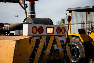 Close-up of machine part against sky