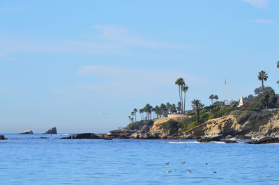 Scenic view of sea against blue sky