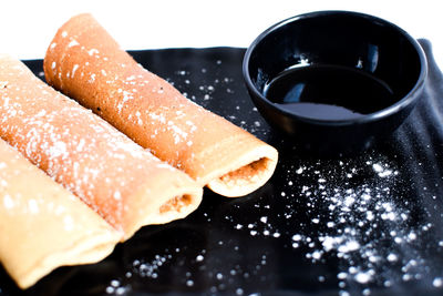 Close-up of rolled crepe against white background