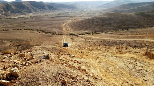 Car on dirt road in desert