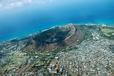 Aerial view of town and mountain by sea