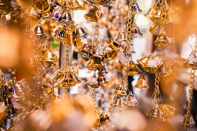 Close-up of bells hanging for sale