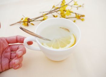 Close-up of hand holding tea cup