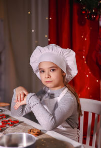 Portrait of cute girl sitting at home