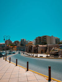 View of buildings against clear blue sky