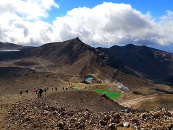 People on mountain road against sky