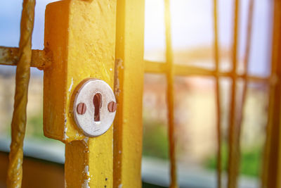 Close-up of warning sign on metal fence