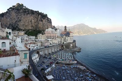 High angle view of buildings by sea against sky