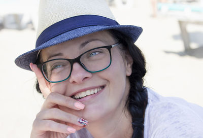 Portrait of smiling young woman wearing hat