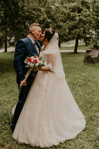 Bride holding wedding dress