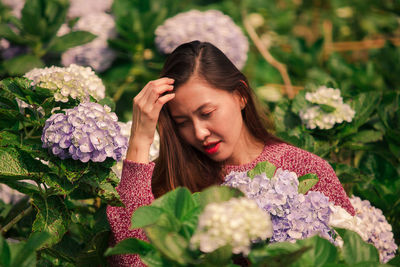 Smiling woman by flowering plants